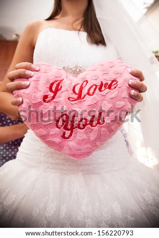 Bride holding I Love You pillow