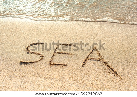 Happy New Year 2020 at sea, the inscription on the beach with a wave and blue sea. Letters sea by the sea, new year concept.