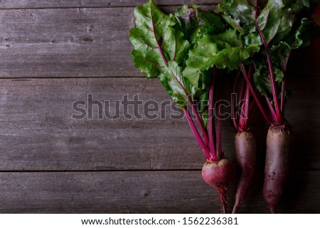 Three beets on wooden background
