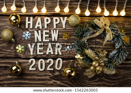 Happy New Year 2020. Symbol from number 2020 on wooden background
