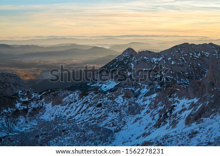Durmitor landscape from Bobotov Kuk. Layers of mountains and clouds. Montenegro national park Durmitor. Sunrise landscape. Copyscape, place for text.