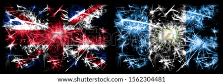 Great Britain, United Kingdom vs Guatemala, Guatemalan New Year celebration travel sparkling fireworks flags concept background. Combination of two abstract states flags.
