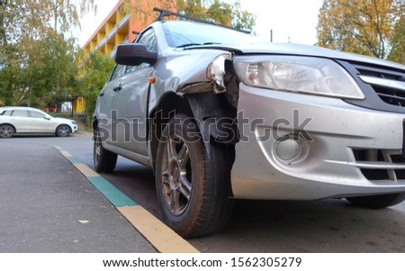 Broken passenger car close-up. Accident, car repair. Royalty-Free Stock Photo #1562305279