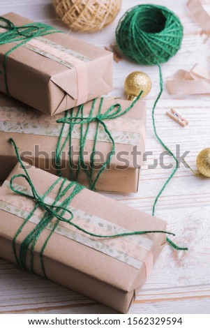 Christmas backgrounds. Gifts and Christmas decor on the wooden background.
