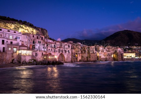 View on habour and old houses in Cefalu at night, Sicily. Beautiful townscape of old italian town. Travel photography.