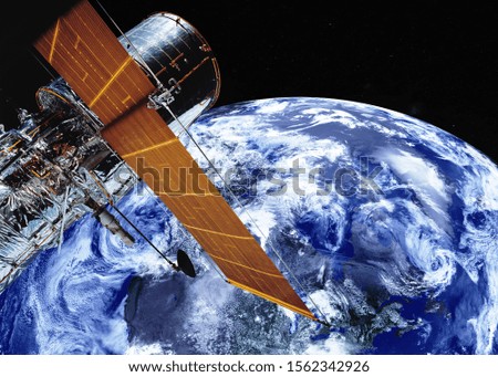 Satellite telescope near Earth planet of solar system somewhere in space. Science fiction. Elements of the image were furnished by NASA