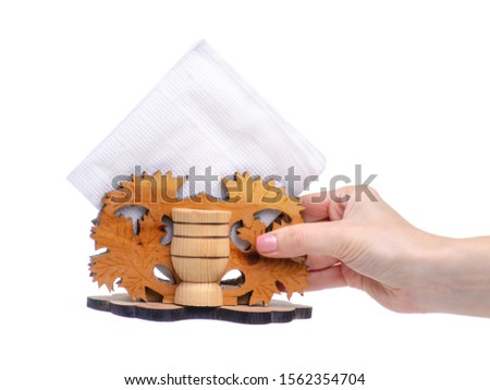 Wooden napkin holder in hand on a white background isolation
