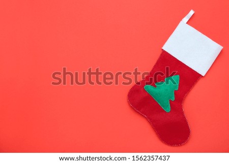 Red christmas stocking on red background
