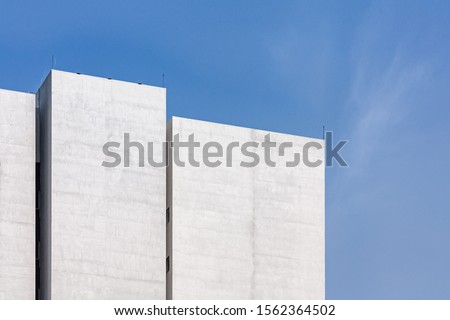 Simple White Concrete Building Corner for Sale or Loan, Basic Abstract Exterior Warehouse or Construction Element Concept, Blue Sky and Cloud in Background with Copy Space