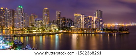 Aerial pano at night of  Miami skyscrapers with colorful lights
