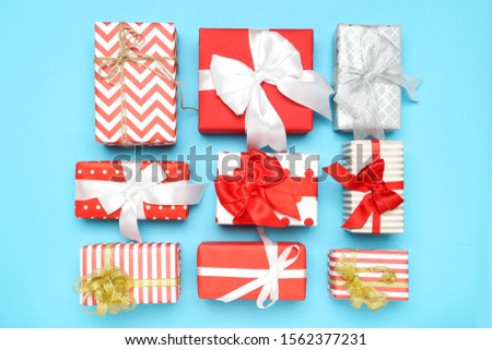 Gift boxes with ribbons on blue background