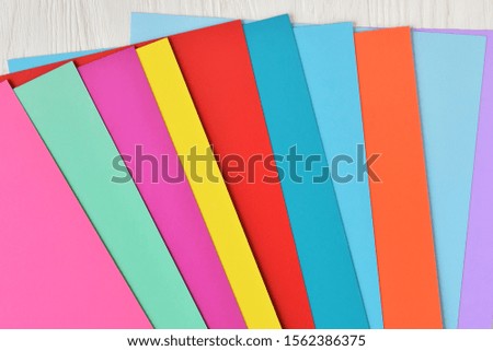 Multicolored background from bright colored paper.  Paper background from colorful sheets of paper. Mockup concept. Neon empty paper background. Blank colorful backdrop with empty space for text