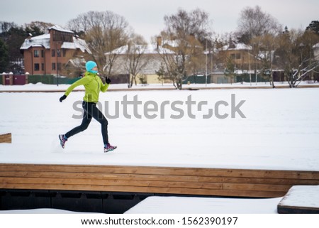 Picture of young athlete running in winter park