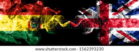 Bolivia, Bolivian vs United Kingdom, British smoky mystic states flags placed side by side. Concept and idea thick colored silky abstract smoke flags