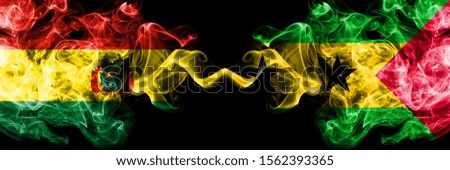 Bolivia, Bolivian vs Sao Tome and Principe smoky mystic states flags placed side by side. Concept and idea thick colored silky abstract smoke flags