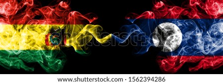 Bolivia, Bolivian vs Laos smoky mystic states flags placed side by side. Concept and idea thick colored silky abstract smoke flags