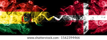 Bolivia, Bolivian vs Denmark, Danish smoky mystic states flags placed side by side. Concept and idea thick colored silky abstract smoke flags