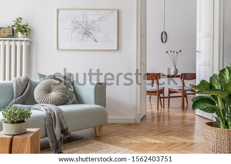 Stylish scandinavian living room with design mint sofa, furnitures, mock up poster map, plants and elegant personal accessories. Modern home decor. Open space with dining room. Template Ready to use.  Royalty-Free Stock Photo #1562403751