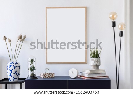 Stylish scandinavian interior design with mock up picture frames, navy blue commode, flowers in vase, books and elegant accessories. Modern home decor. Living room. Template Ready to use. 