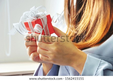 Close up red surprise gift box on woman 's hand