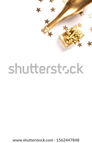 Decorated Bottle of Golden Champagne with  with presents and traditional decor on a white background.Symbol of Christmas and New Year. Holiday tradition for party. Flat lay.Copy space .