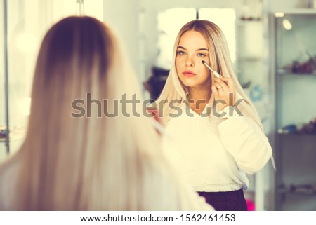 Caucasian woman blogger creating beauty video blog. Female makeup artist recording cosmetics apply tips. Smiling blond lady freelance visagist. 