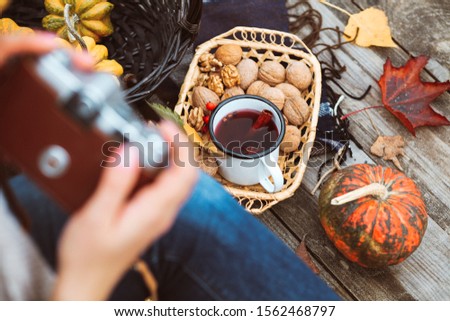 Trendy and attractive beautiful woman with analog vintage camera makes photos for food blog, creates content for social media channels and applications, popular influencer, food blogger