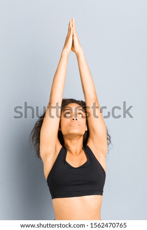 Young african american sporty woman practicing yoga