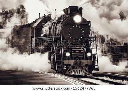 Steam train departs from Riga railway station. Moscow. Russia. Royalty-Free Stock Photo #1562477965