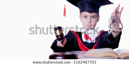 Humorous photo of beautiful young girl judge holding gavel and handcuffs as symbol of principle of justice and fairness