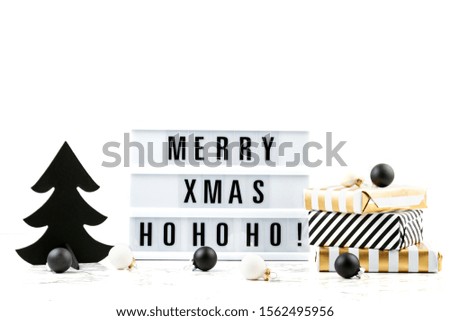 Trendy fashionable christmas decoration with gifts, light box  in black and white colors