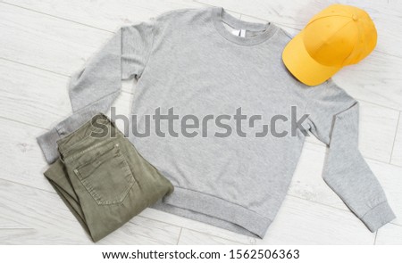 Clothes background top view, empty shirt fir your logo copy space mock up, t-shirt mockup isolated on wooden floor, summer vacation concept, male and female t shirt
