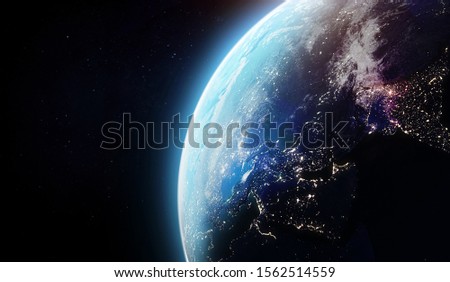 Nightly and dawn Earth in the outer space. Abstract wallpaper for background. City lights on planet. Elements of this image furnished by NASA