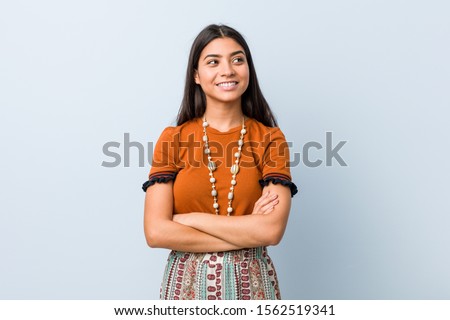 Young arab woman smiling confident with crossed arms.