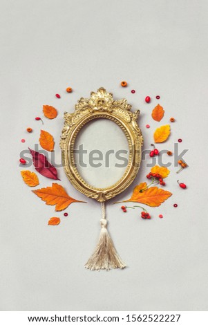 Top view of a beautiful golden frame with colorful fallen leaves, in shape of a tree; autumn composition with copy space 