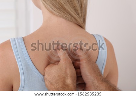 Neck Pain trigger points/ Chiropractic back treatment. Physiotherapy for female patient, Sport Injury Recovery Royalty-Free Stock Photo #1562535235
