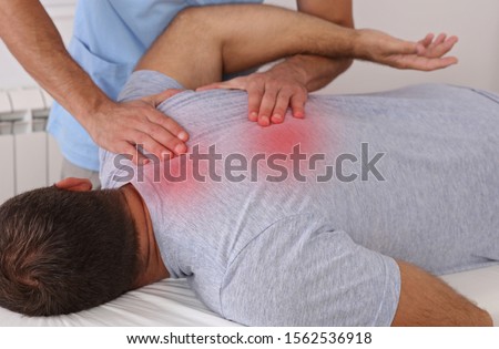 Chiropractic treatment. Shiatsu massage, Back Pain trigger points. Physiotherapy for male patient, Sport Injury Recovery Royalty-Free Stock Photo #1562536918