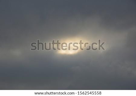 The sun breaks through the clouds in sky