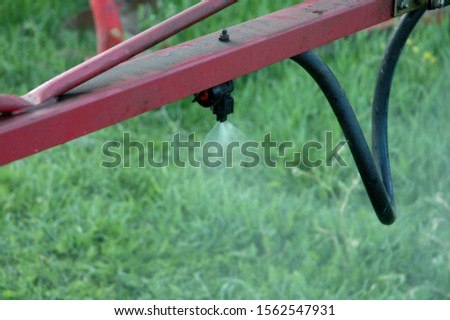 Spray boom from a sprayer. Spray liquid glyphosate herbicide against couch grass and dandelion Royalty-Free Stock Photo #1562547931