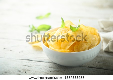 Homemade potato chips with fresh basil