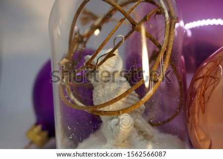 Christmas Decoration close-up. Toy glass white strasy owl. New Year's baubles macro photo with bokeh. Winter holiday light decoration                                                