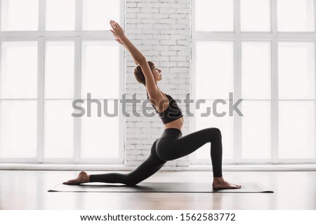 Beautiful woman training and practicing yoga at class. Girl doing exercises at home. Harmony, balance, meditation, relaxation, healthy lifestyle concept