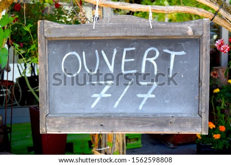 Open seven days a week sign in French language on Aubonne street, Switzerland.