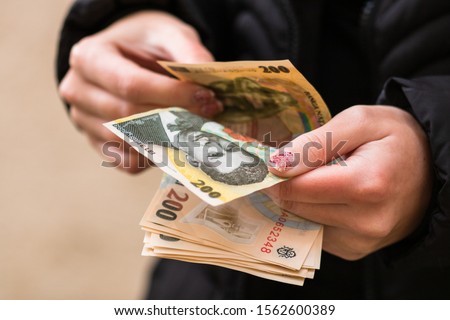 Girl hands counting money, counting Romanian LEI currency, close up Royalty-Free Stock Photo #1562600389