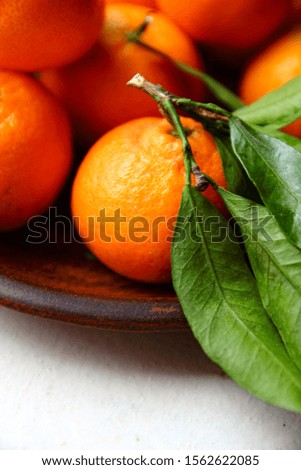Tangerines on circle plate and white background 