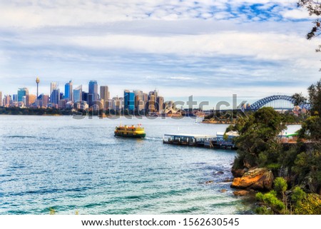 Passenger Ferry on Sydney Harbour from Taronga wharf towards city Circular quay destination in view of Sydney waterfront on a sunny day.