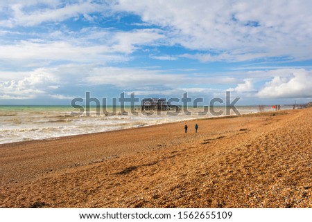 Panoramic view of Brighton's beach. In the background they are the remains of Brighton West Pier in sea. UK.