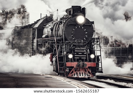 Steam train departs from Riga railway station. Moscow. Russia. Royalty-Free Stock Photo #1562655187
