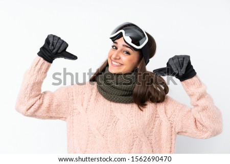 Skier girl with snowboarding glasses over isolated white wall proud and self-satisfied