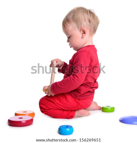portrait of cute little caucasian baby play with toys. isolated on white background. baby 1 year